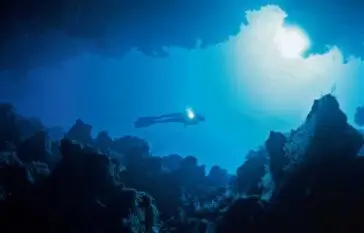 Atlantic Scuba Diver with light underwater